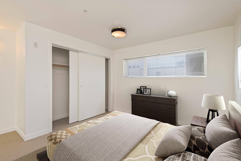 a bedroom with a large bed and a dresser