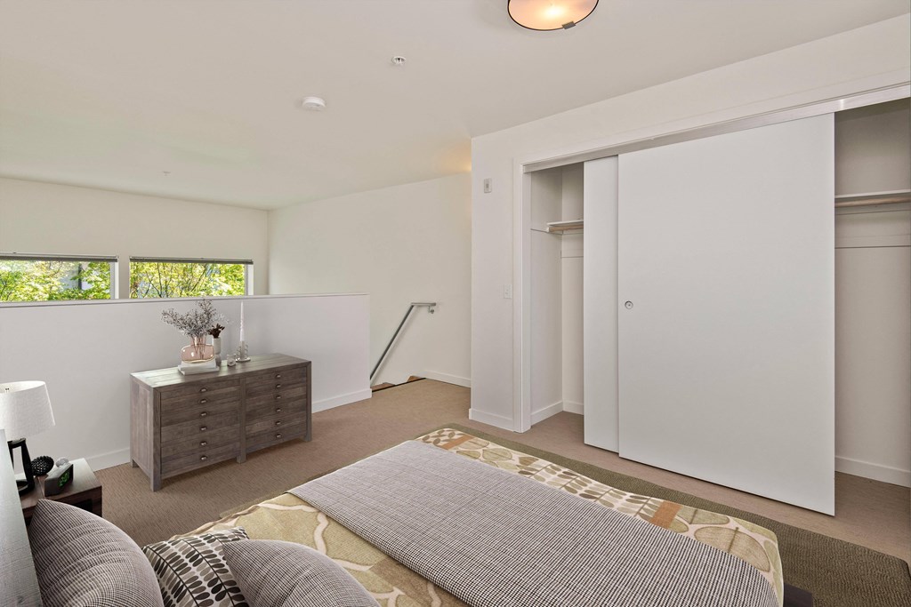 a bedroom with a bed and a dresser