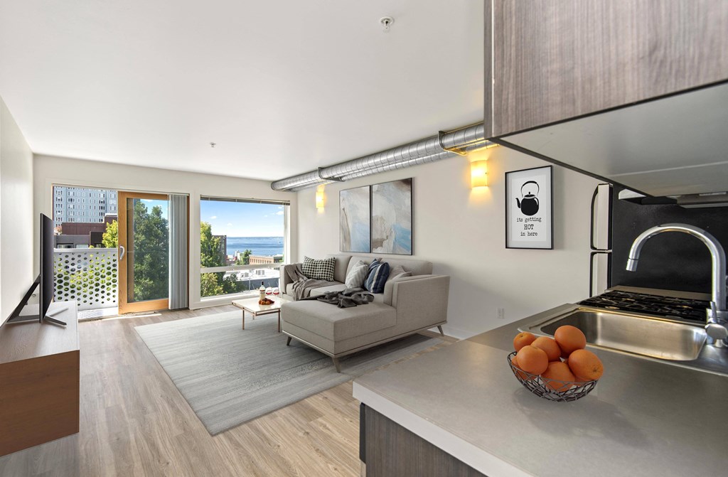 a kitchen with a stove top oven next to a couch