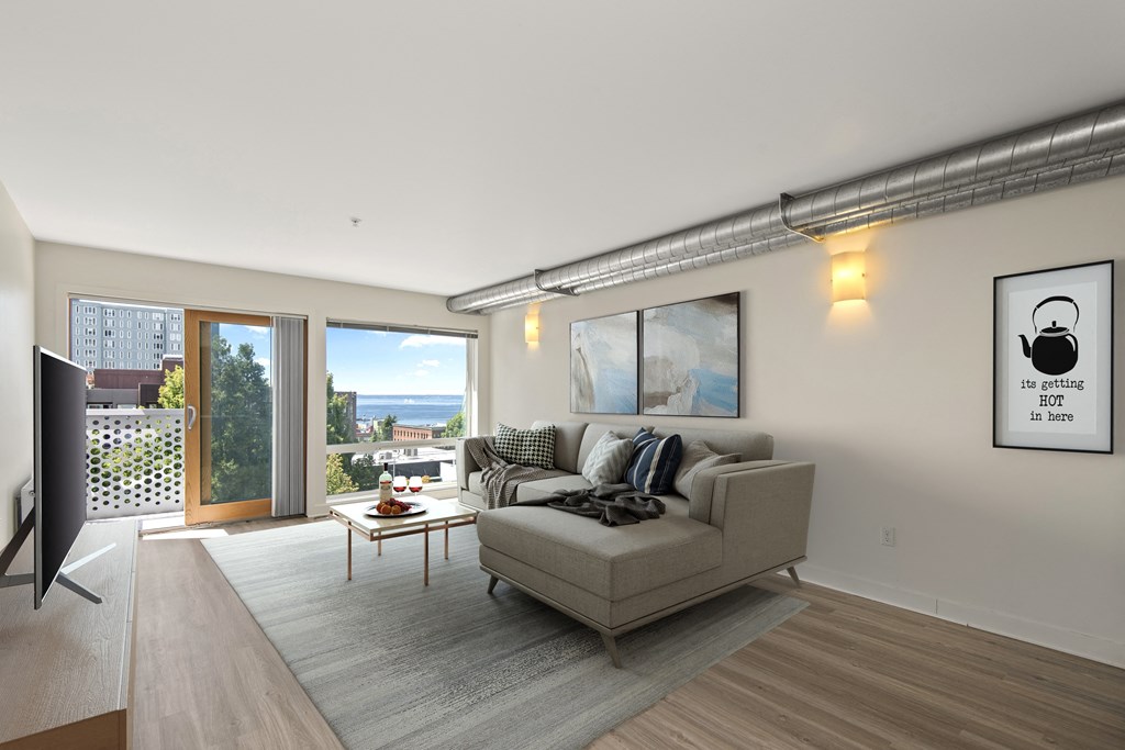 Belltown, WA Apartments - Emmons On 3rd - Open-Concept Living Room With Hardwood Flooring, High Ceilings, Expansive Windows With Expansive Views, And Access To Private Balcony.