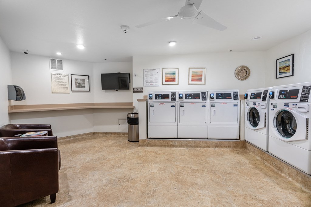the laundry room is equipped with washes and dryers and a television