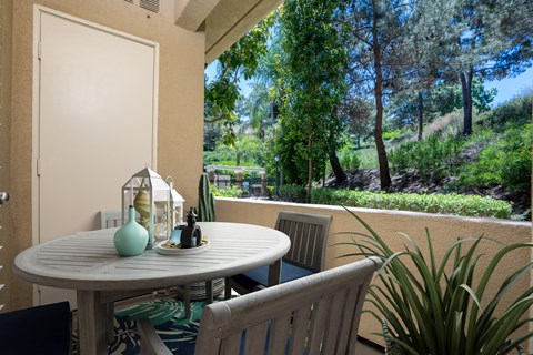 a patio with a white table and chairs at 55+ FountainGlen Laguna Niguel, California