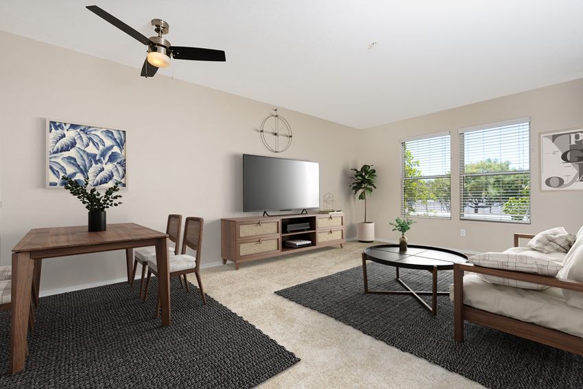 a living room with a ceiling fan and a flat screen tv - Photo Gallery