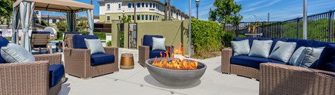 pool area chairs and a fire pit at 55+ FountainGlen Valencia, California
