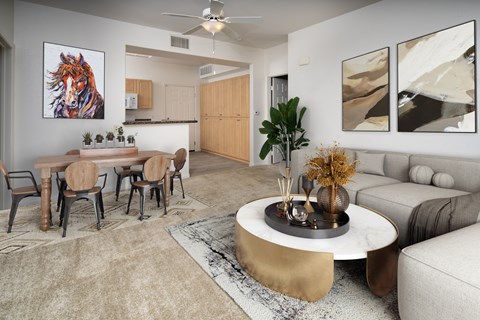 A living room with a dining table and chairs.