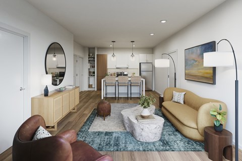 A modern living room with a yellow sofa and a round mirror on the wall.