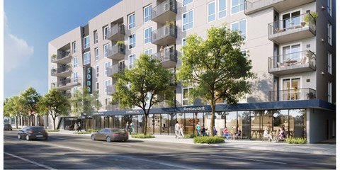 A modern apartment building with a restaurant on the ground floor.