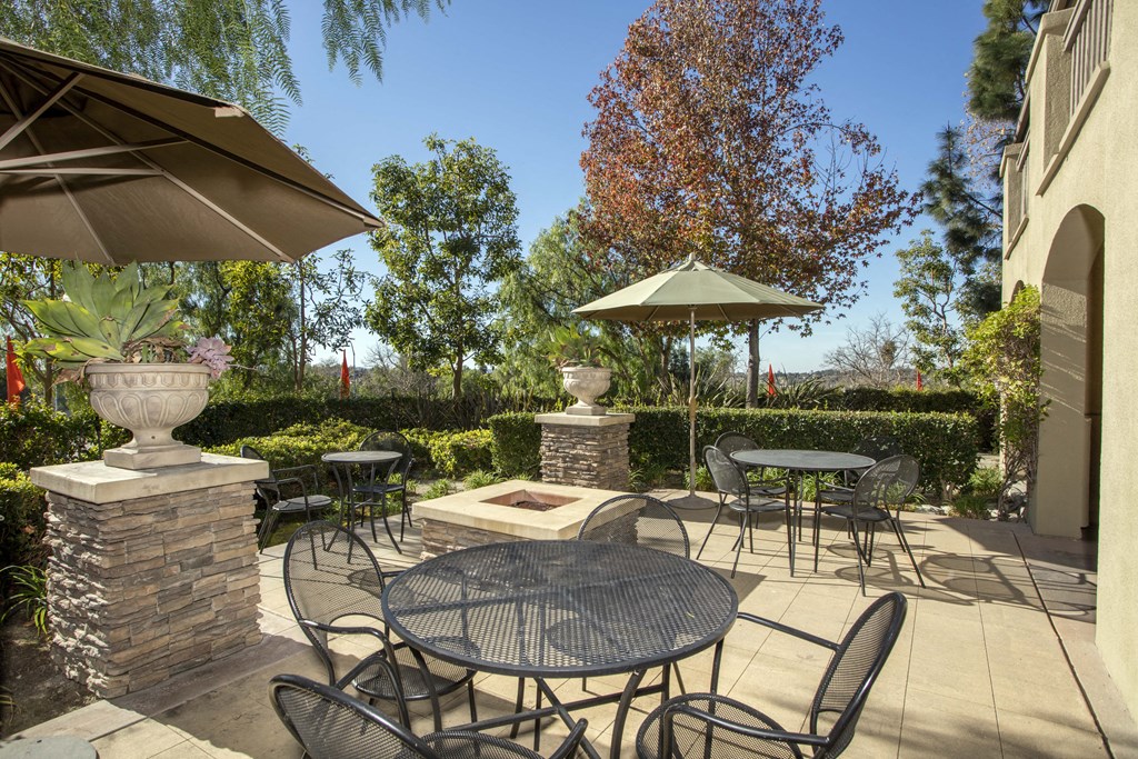 a patio with a firepit and tables and chairs at 55+ Remington at Ladera Ranch, Ladera Ranch