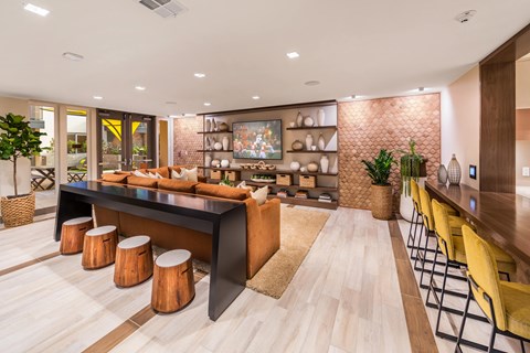 the living room has a bar and a dining area with stools