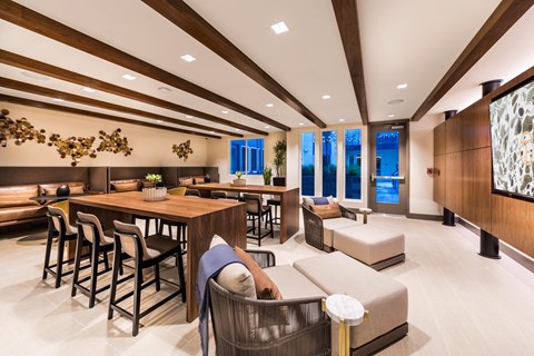 the lobby of a hotel with tables and chairs and a couch