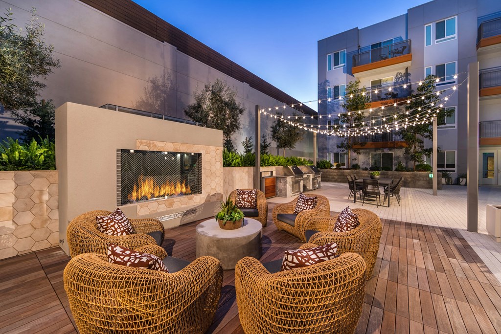 an outdoor patio with chairs and a fire pit