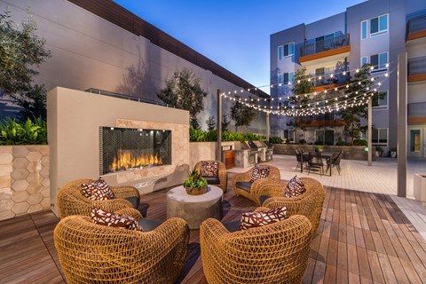 an outdoor patio with chairs and a fire pit