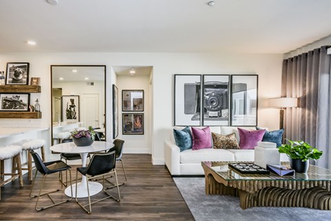 a living room with a white couch and a table and chairs