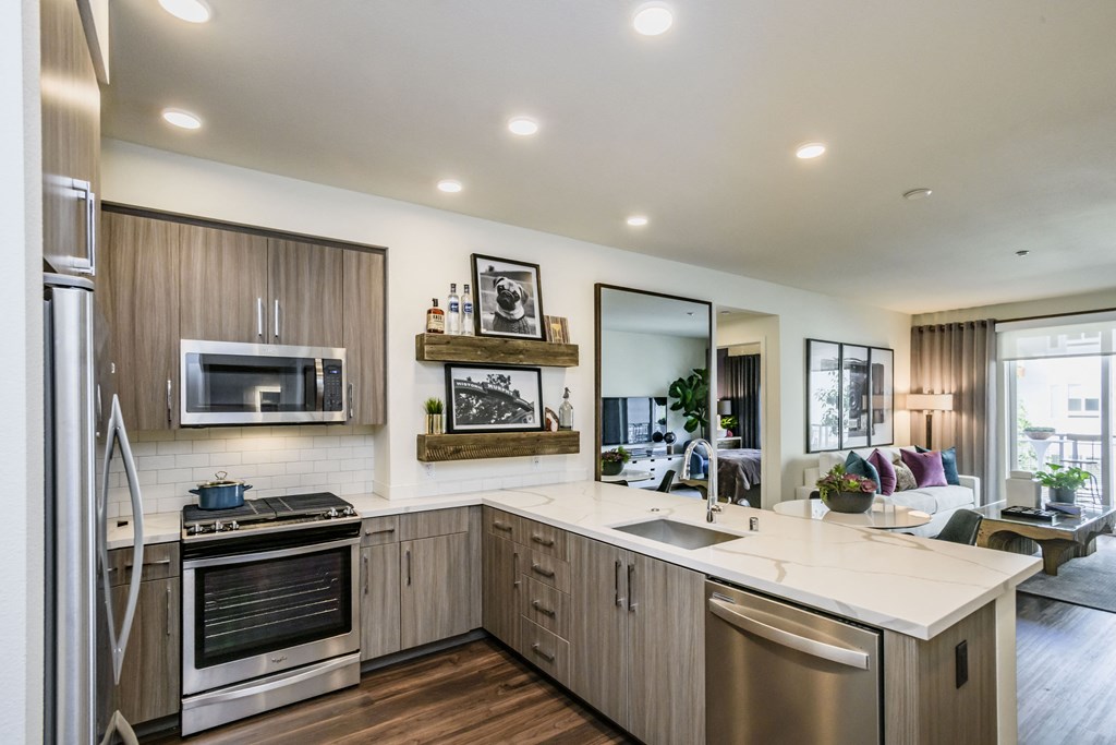 a kitchen with stainless steel appliances and a white counter top