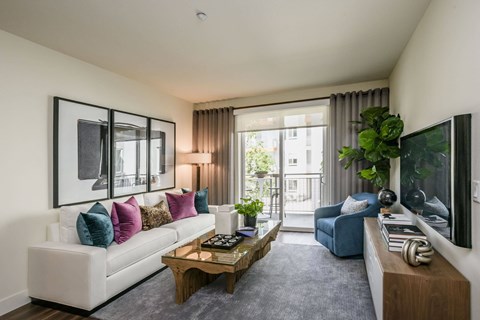 a living room with a white couch and a coffee table