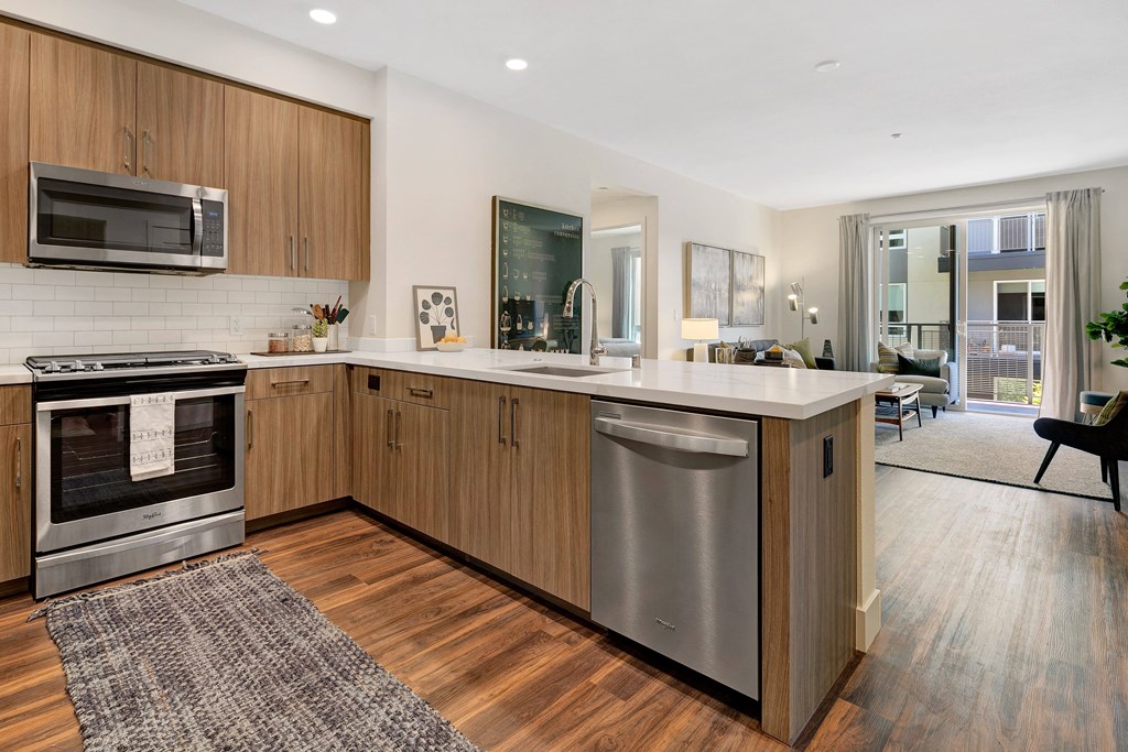 a kitchen with an island and stainless steel appliances