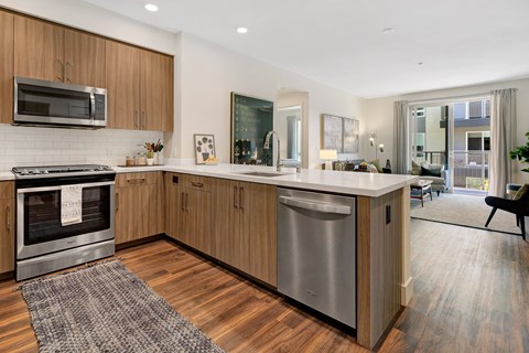 a kitchen with an island and stainless steel appliances