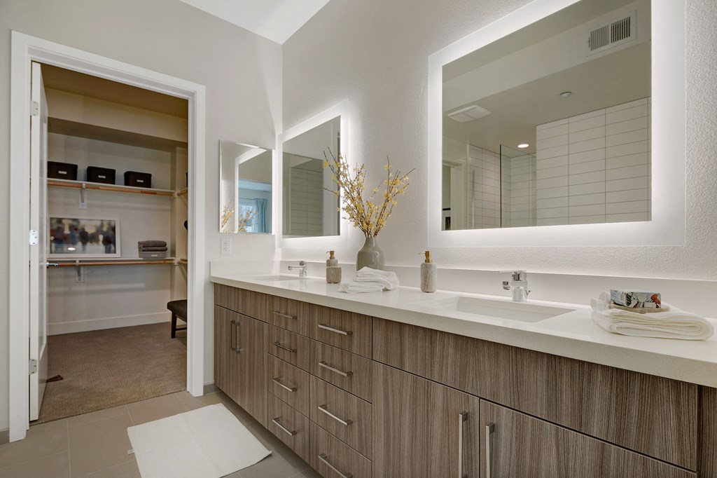 a bathroom with two sinks and a large mirror