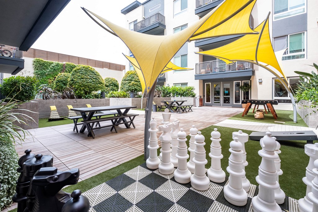 a large chess set in the courtyard of a building