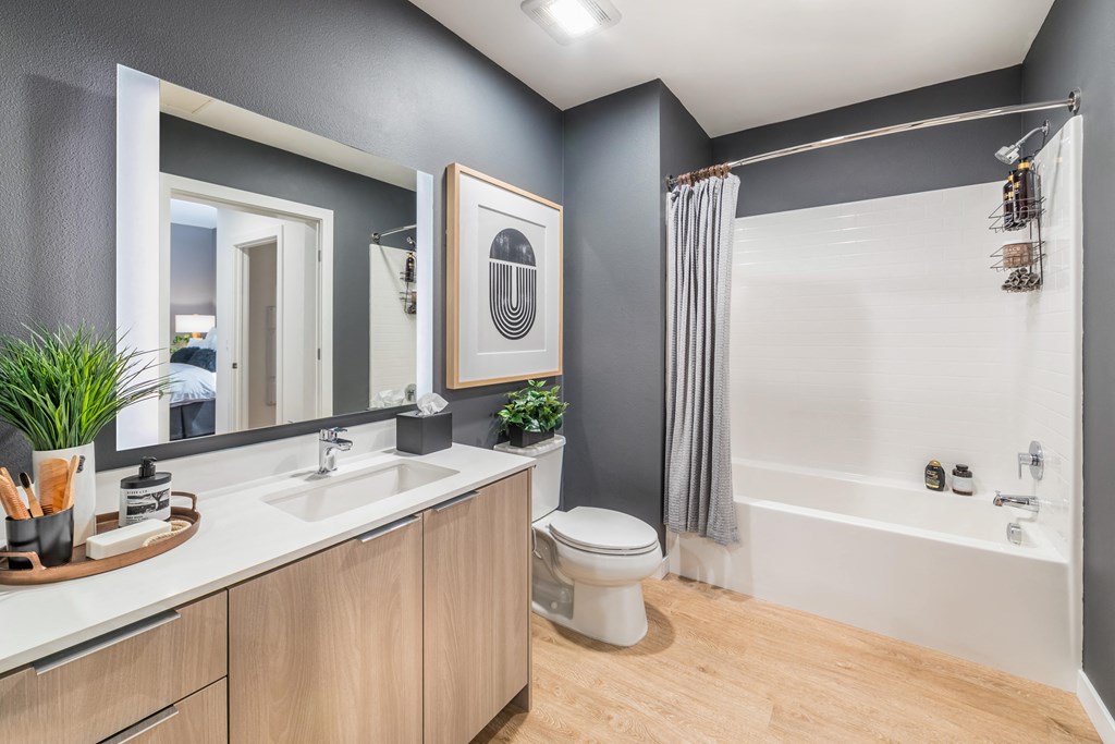 a bathroom with a shower and a sink and a toilet