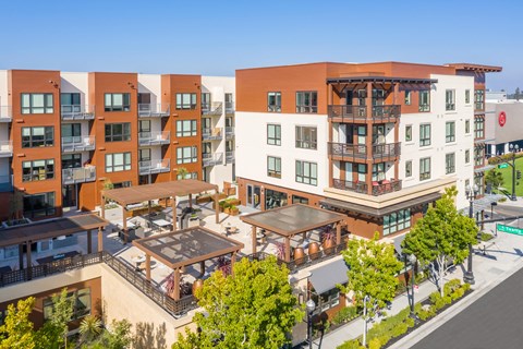 an aerial view of an apartment complex with balconies and trees