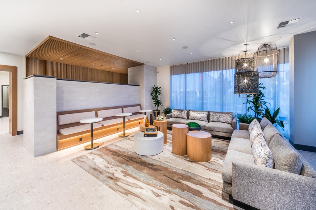 a living room filled with furniture and a large window