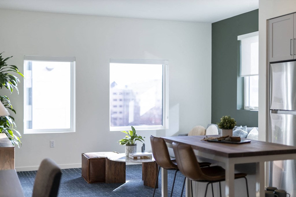 Dining area and living room with windows