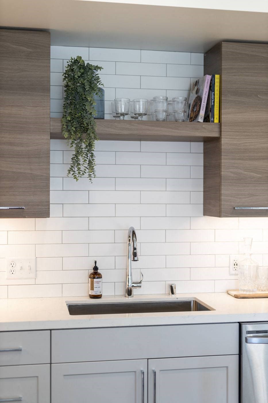 Kitchen with stove, tiled backsplash and wooden cabinets