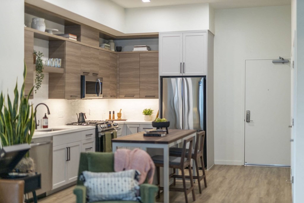 a kitchen and dining room with a table and chairs