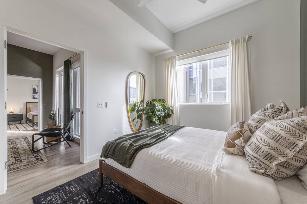 a bedroom with a bed and a large window