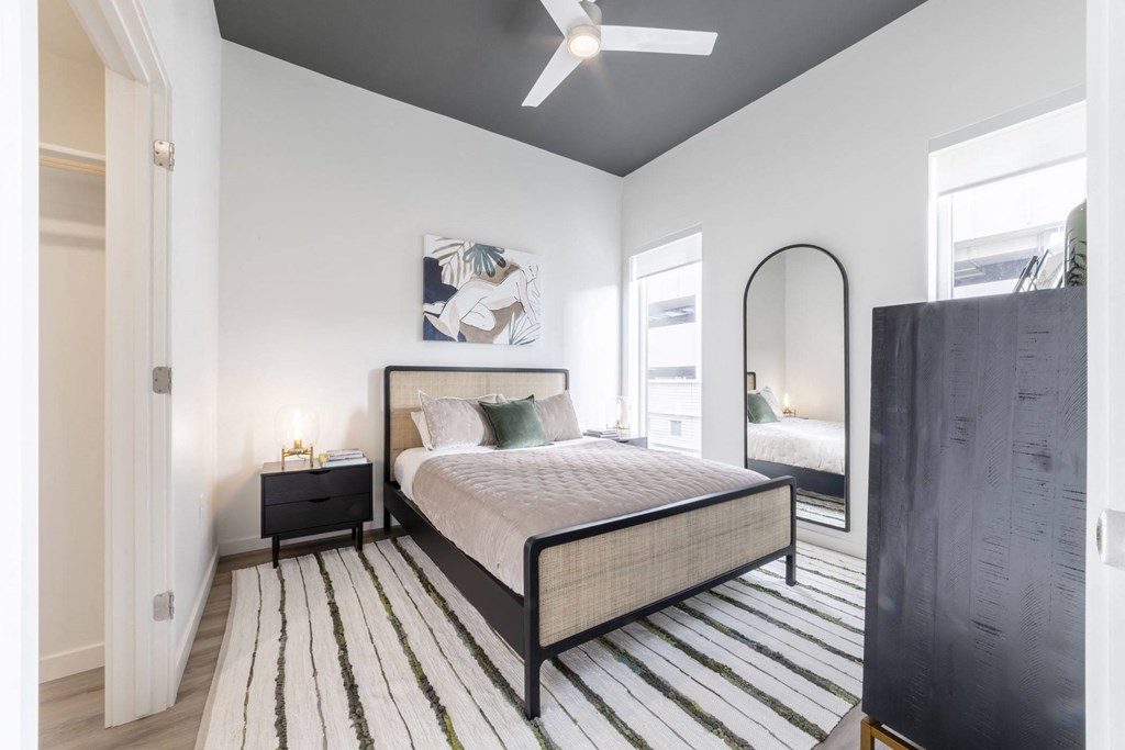 Bedroom with ceiling fan and windows