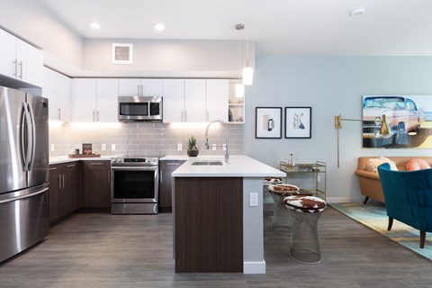 a kitchen with stainless steel appliances and a white counter top
