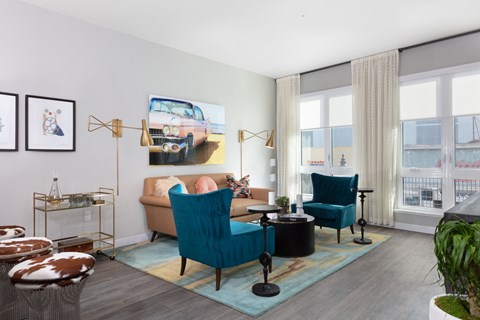 a living room with blue chairs and a couch