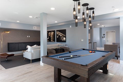 a large game room with a pool table and a tv