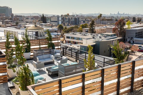 a roof deck with a city in the background
