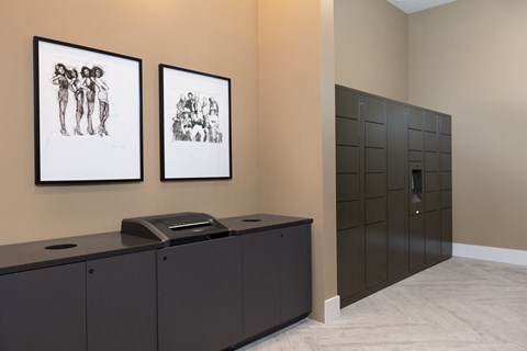 an office with two pictures on the wall and a desk with a filing cabinet