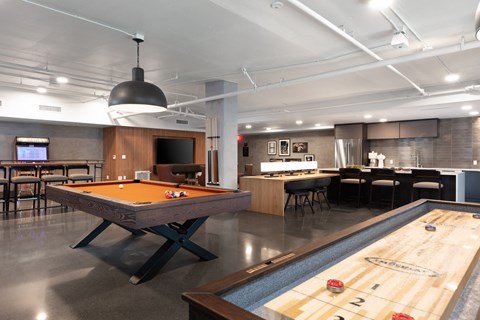 a game room with a pool table and a bar