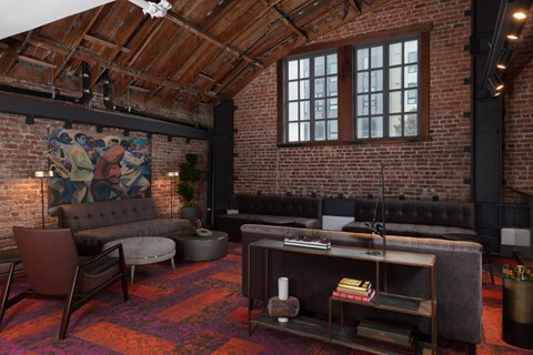 a living room with exposed brick walls and leather furniture