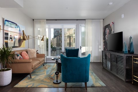 a living room with a couch and a chair and a television