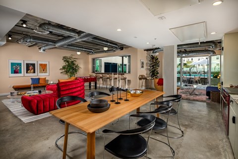 A modern dining room with a wooden table and chairs.