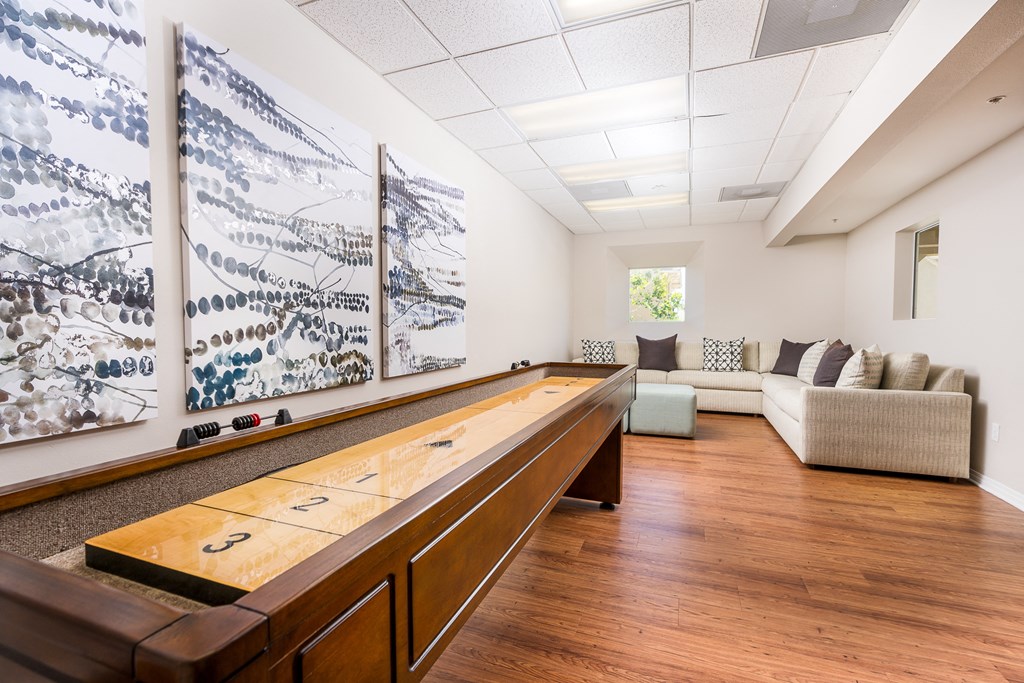 a game room with a shuffleboard table and couches at 55+ FountainGlen Temecula, Temecula, CA, 92591
