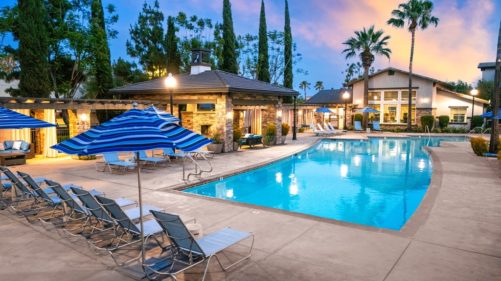 Poolside area with lounge chairs at The Grove Apartments, Ontario, 91761