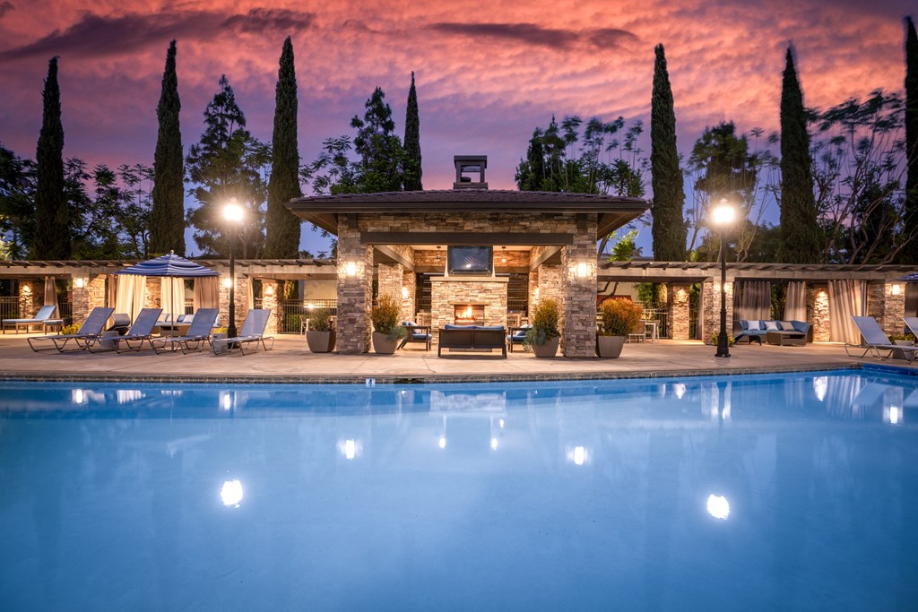 House with a pool in front of it at The Grove Apartments, Ontario, CA