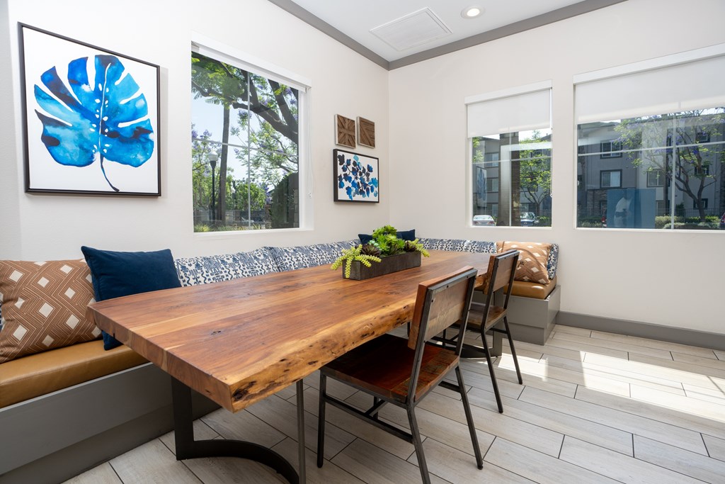 Wooden table with chairs at The Grove Apartments, California