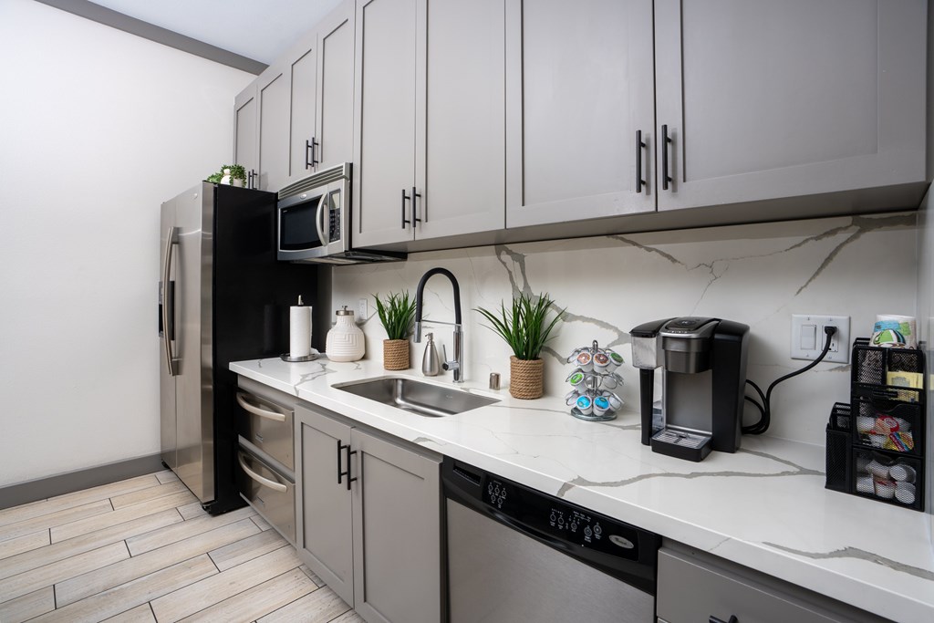 Kitchen with a black fridge at The Grove Apartments, Ontario, 91761