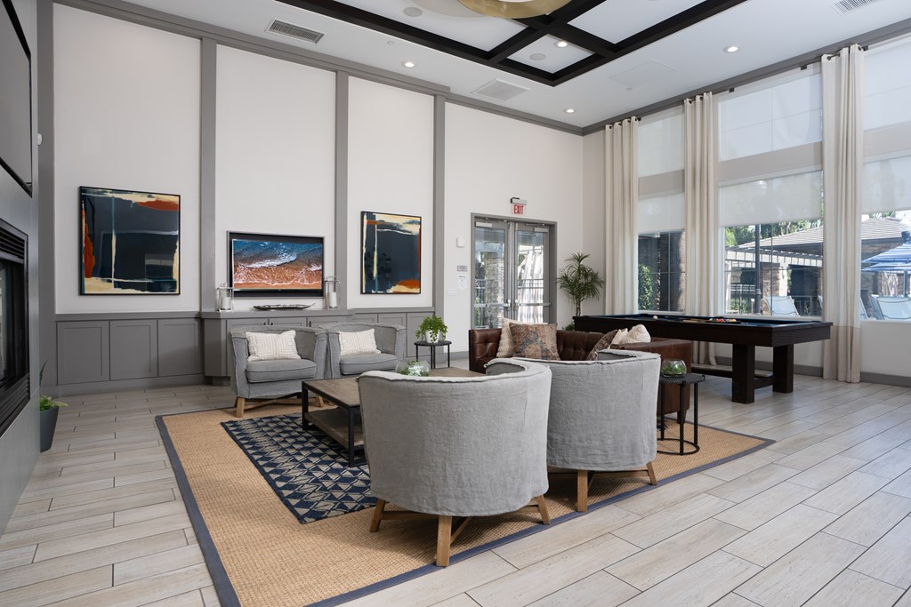 Living room with grey sofa at The Grove Apartments, California, 91761