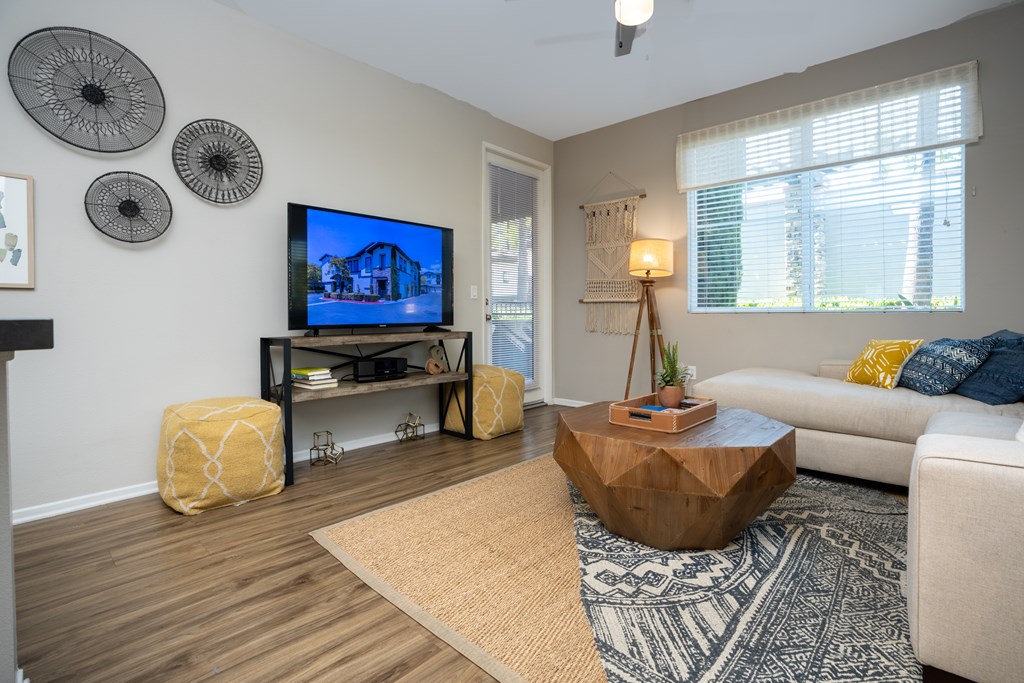 Living room with a television at The Grove Apartments, Ontario, CA