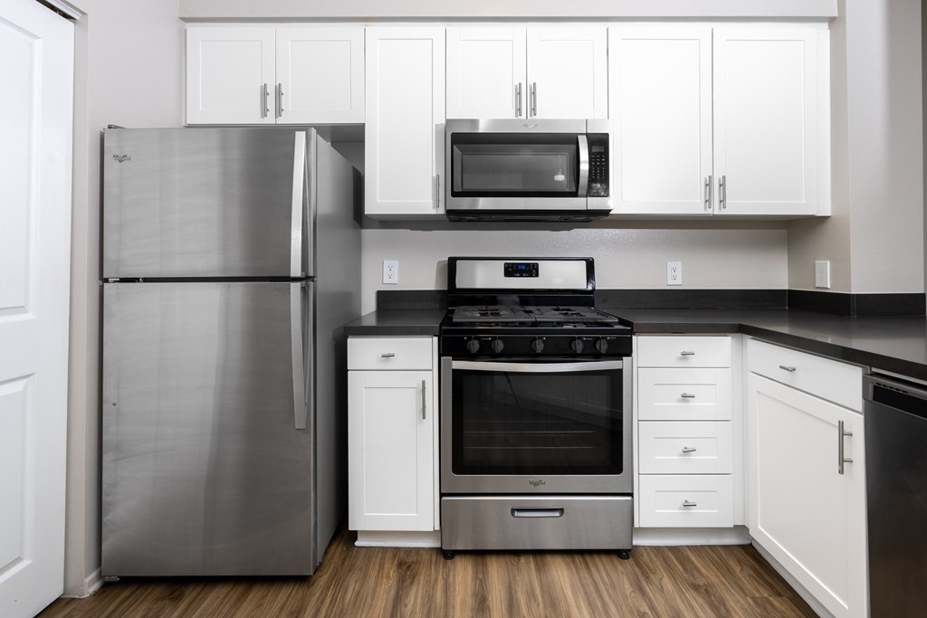 Modern kitchen with stove top oven at The Grove Apartments, Ontario, California