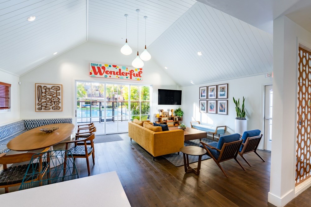 A living room with a white table and chairs.