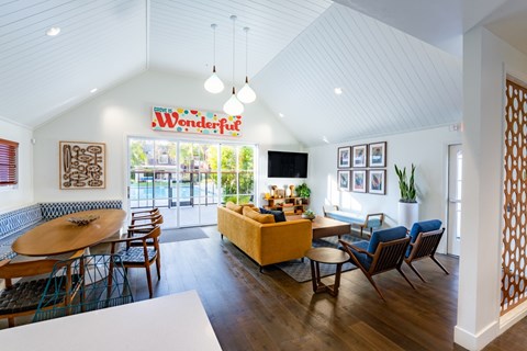 A living room with a white table and chairs.